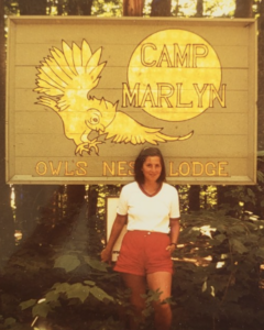 Anouk in front of an American summer camp sign